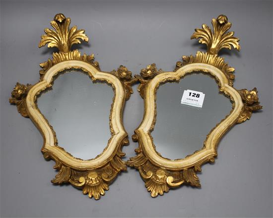 A pair of Italian giltwood cartouche shaped wall mirrors, width 25cm, height 43cm